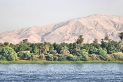 Nile River bank near Aswan, showing narrow irrigated strip giving way quickly to desert