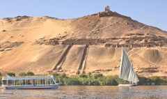Nile River bank near Aswan, Aga Khan's Mausoleum on hill