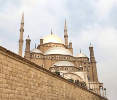The Alabaster Mosque is visible behind a wall of the Citadel in Cairo