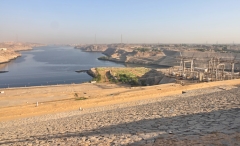 Standing on the Aswan High Dam wall and looking north at the continuing Nile. There are hydroelectric works on the right.